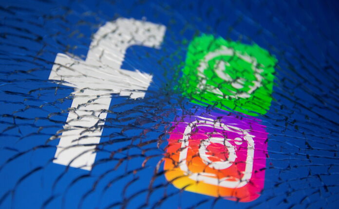 Facebook, Whatsapp and Instagram logos are displayed through broken glass in this illustration